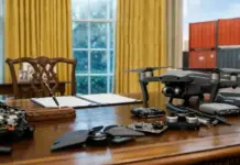 New Tariffs on Drones and Parts due to Foreign Supply Chains Drone and its disassembled parts spread across a wooden desk in a sunlit room, with a notebook and pen nearby.